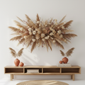 Large dried pampas and floral wall installation above a console in a stylish living room