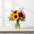Colorful seasonal flower posy in a glass mason jar
