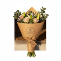 Fresh flower bouquet on a doorstep in branded kraft packaging
