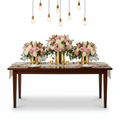 Three matching lush floral centerpieces on an elegantly set dining table